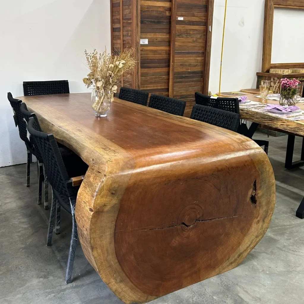 Mesa cascata de prancha maciça com lateral em tronco e cadeiras pretas trançadas, Curitiba
